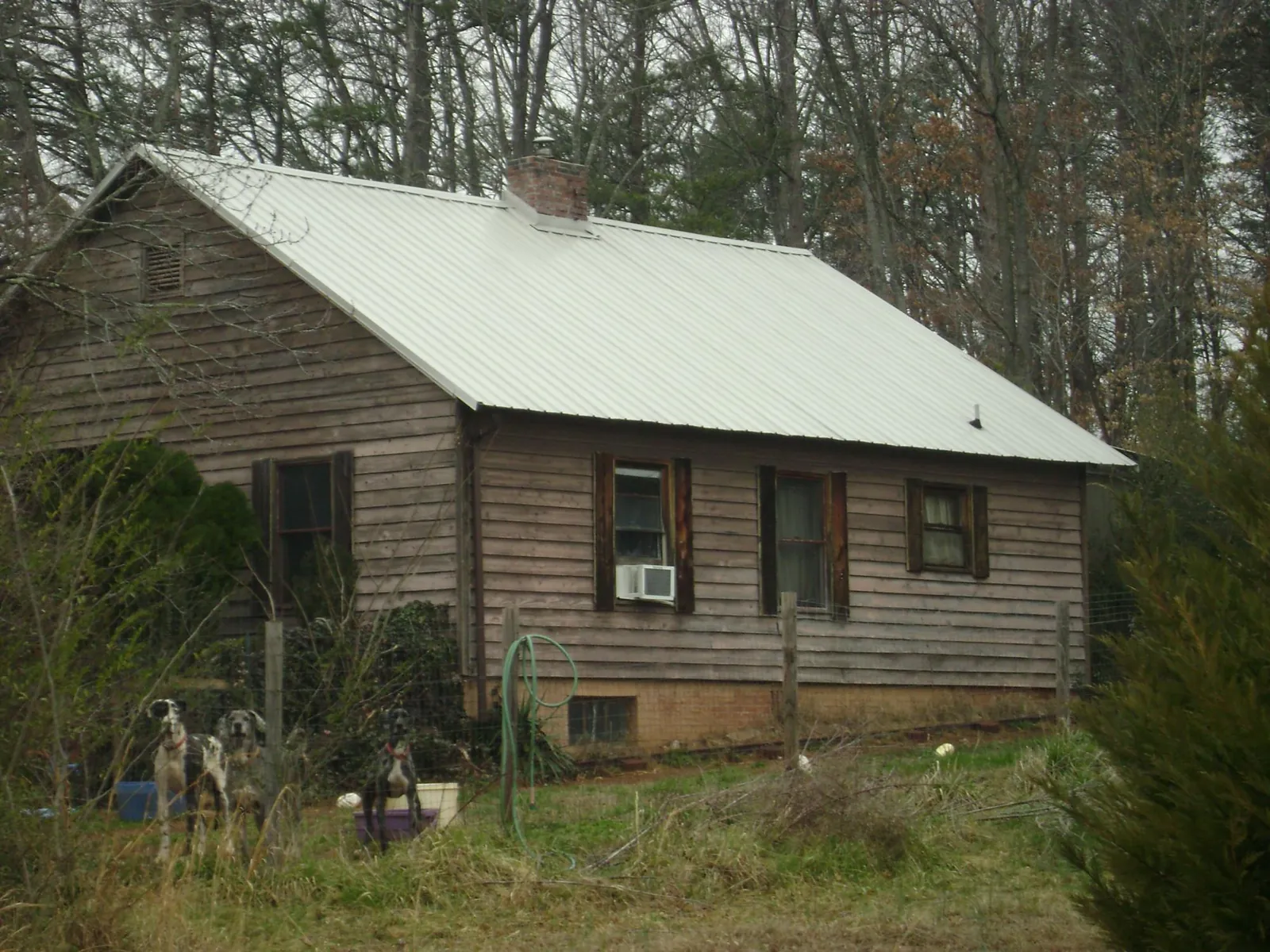 White metal roof on an old wood sided farmhouse, from a Metal Roof Installation job in Honeoye Falls